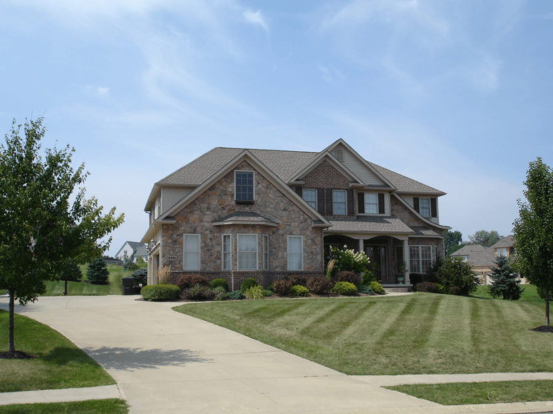 Exterior of large home with faux stone siding