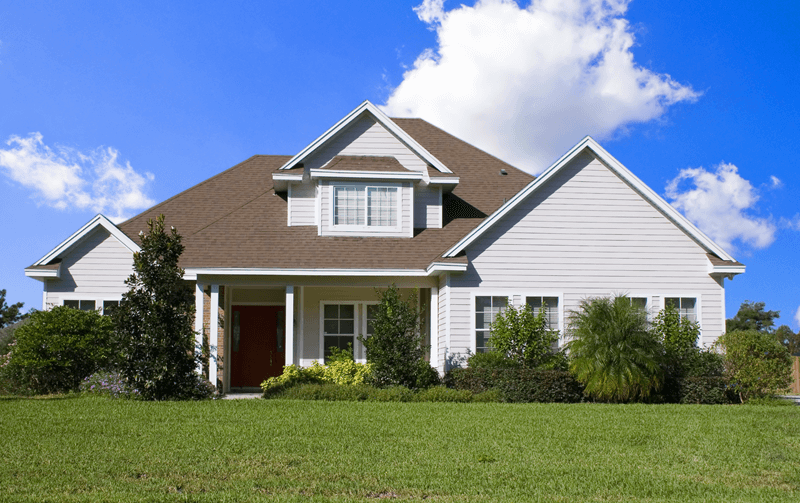 Exterior of white single family home with bright blue sky