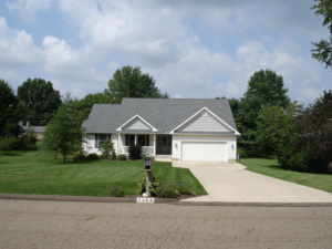 Exterior of white single family home with large lawn