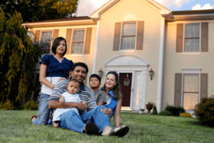 Family of 5 on lawn in front of their home