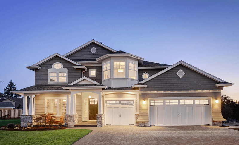 Grey single family home exterior in evening