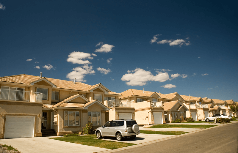 Row of beige and cream single family homes